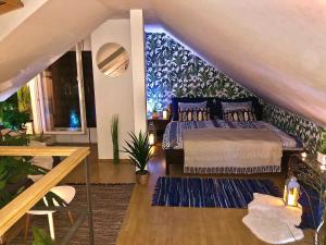 a bedroom with a king sized bed in a attic at Duplex with quite terrace on Wenceslas sq. in Prague