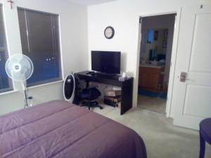 a bedroom with a bed and a desk with a television at Room in Campbell with Own Bthrm in Campbell