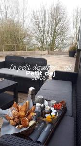 a table with a tray of food on a patio at La Petite Motte in Ceton