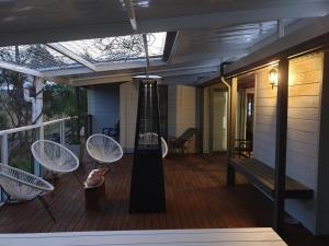 a porch with chairs and a bench on a house at Charolais Cottage in Picton