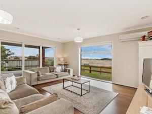 a living room with a couch and a fireplace at Little Croft in Port Fairy