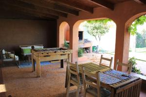 a living room with a table and chairs and a table at Finca Paredes in Valdetorres de Jarama