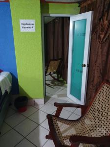 a room with a door and two chairs and a mirror at hotel kasa kamelot 2 in Quetzaltenango