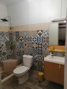 a bathroom with a toilet and a sink at Le Bon Refuge in Le Lamentin +8 photos