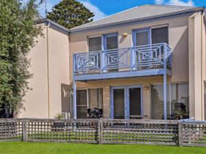 a house with a balcony and a fence at Moyne Views 2 in Port Fairy