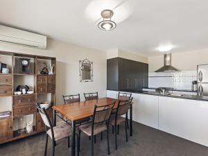 a kitchen with a table and chairs in a room at Moyne Views 2 in Port Fairy