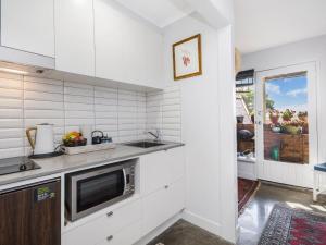 a kitchen with a sink and a microwave at Pea Soup Beach in Port Fairy