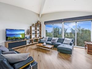 a living room with two couches and a tv at Port Fairy Beach House in Port Fairy