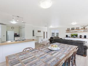 a kitchen and living room with a table and a couch at Rossanna in Port Fairy