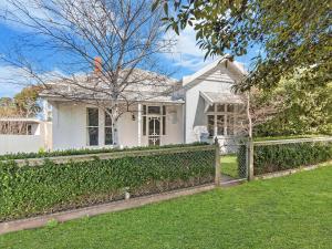 a white house with a fence in front of it at Riverend Regent in Port Fairy