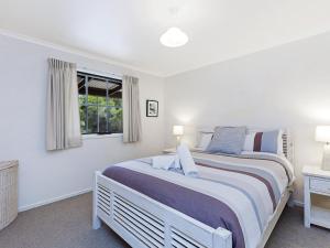 a bedroom with a large bed and a window at Rossanna in Port Fairy