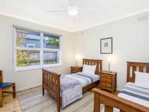 a bedroom with two beds and a window at Rossleague House in Port Fairy