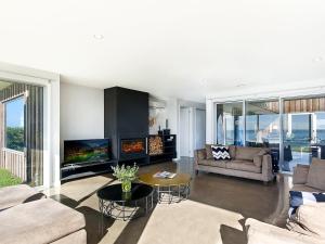 a living room with two couches and a fireplace at Saltwater Lodge in Port Fairy