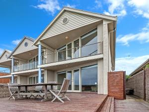 a house with a table and chairs on a deck at Rubys Beachfront in Port Fairy