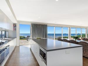 cocina blanca con vistas al océano en Saltwater Retreat, en Port Fairy