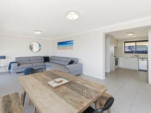 a living room with a table and a couch at Seaclusion in Port Fairy