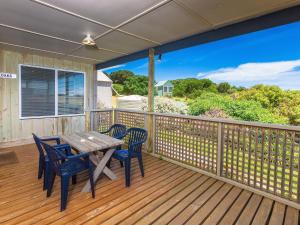 a wooden deck with a table and chairs on it at Sheoaks Cottage in Port Fairy