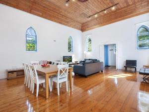 a living room with a table and a couch at The Church in Port Fairy +1 photo