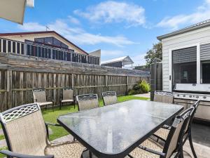a patio with a table and chairs and a fence at The Townhouse in Port Fairy