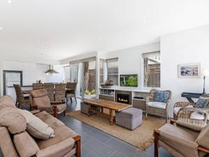 a living room filled with furniture and a fireplace at The Townhouse in Port Fairy