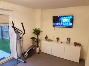 een kamer met een fitnessruimte met een televisie en een loopband bij Liverpool Anfield in Liverpool