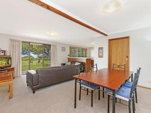 a living room with a table and a couch at Waters Edge in Port Fairy