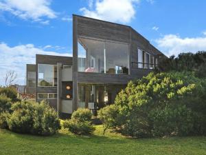 a house with large glass windows on a hill at Whispers in Port Fairy