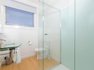 a bathroom with a glass shower stall and a toilet at Wytonia 3 Penthouse in Port Fairy