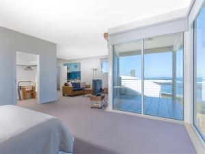 a bedroom with a bed and a view of the ocean at Wytonia 3 Penthouse in Port Fairy