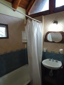 a bathroom with a sink and a shower curtain at Mar de los Poetas in Mar Azul