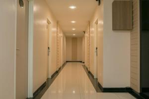 a corridor of a hotel with white walls and a long hallway at Savana Hotel & Serviced Apartments in Kuala Perlis