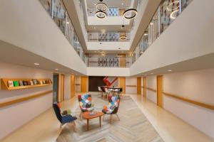 a lobby of a hospital with chairs and tables at Ginger Madgaon, Goa in Madgaon