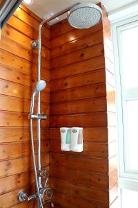 a bathroom with a wooden wall with two toilets at Bluejay Residences in Hong Kong