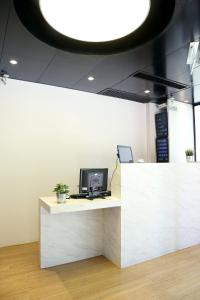 a white counter with a computer on top of it at Bluejay Residences in Hong Kong