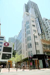 a tall building in a city with tall buildings at Bluejay Residences in Hong Kong