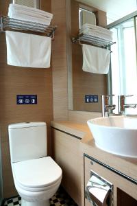 a bathroom with a toilet and a sink at Bluejay Residences in Hong Kong +8 photos