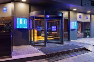 an entrance to a hotel with a sign that reads try at Tryp By Wyndham Istanbul Sancaktepe in Istanbul