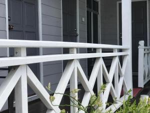 a white fence on a house with a door at Suhaila Palace in Perhentian Islands