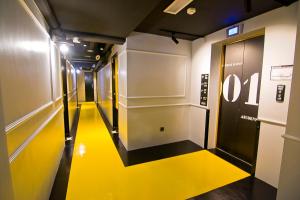 a hallway with a yellow floor in a building at JonkeRED Heritage Hotel in Melaka