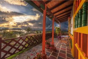 a balcony of a house with a view of the ocean at Hotel Zocalo Campestre in Guatapé
