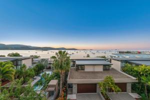 an aerial view of a building with the beach in the background at Executive on Whisper Bay - Cannonvale in Airlie Beach