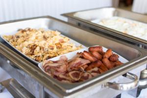 a tray of food with bacon and other food at Riviera Perdika Hotel in Perdika