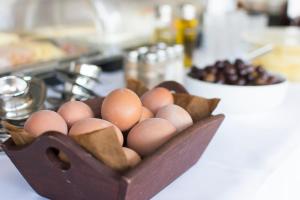 a bunch of eggs in a wooden bowl on a counter at Riviera Perdika Hotel in Perdika