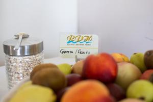 a pile of fruit next to a container of oats at Riviera Perdika Hotel in Perdika