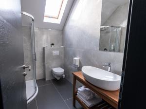 a bathroom with a sink and a shower and a toilet at B&B Villa Dolina Plitvice in Plitvička Jezera