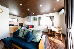 a living room with a blue couch and a table at 22 ORIYA Mt Fuji -錦NISHIKI- in Fujikawaguchiko