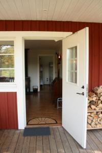 an open door of a house with a porch at Grönelid Gård in Tived