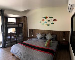 a bedroom with a bed and a dresser at Coco Lanta Resort - SHA Extra Plus in Ko Lanta