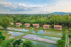 an aerial view of a farm with a group of houses at COOLLiving Farmhouse Organic in Wang Nam Khieo