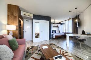 a living room with a couch and a table at Hotel Luze El Villa in Castejón